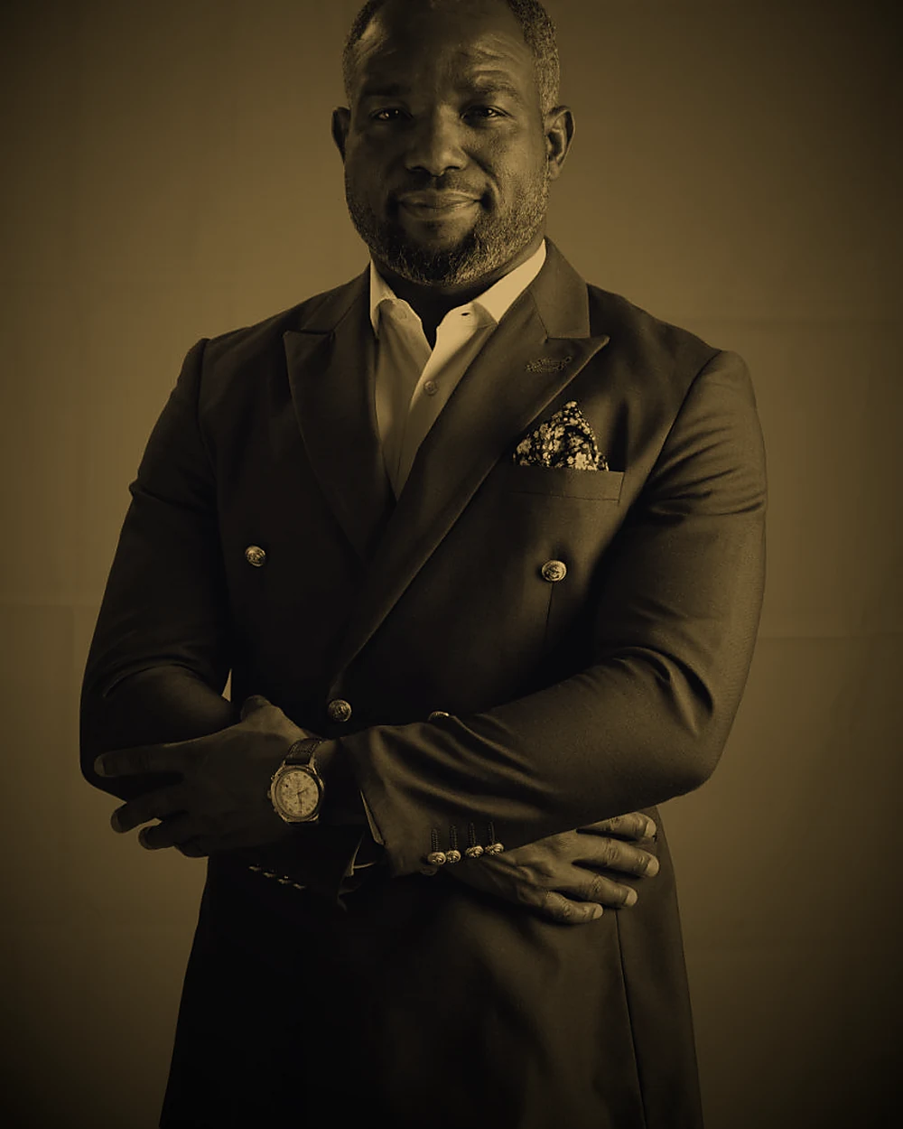 Pastor Pedro photographed in a dark double-breasted suit