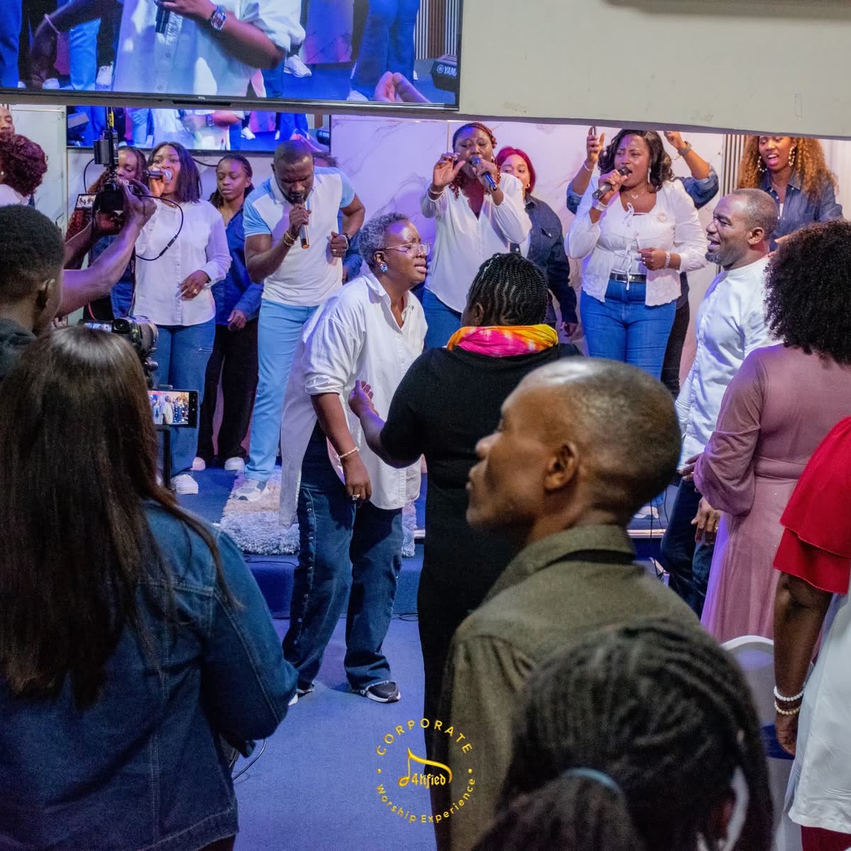 The worship team ministering to a full room at a Corporate Worship Experience